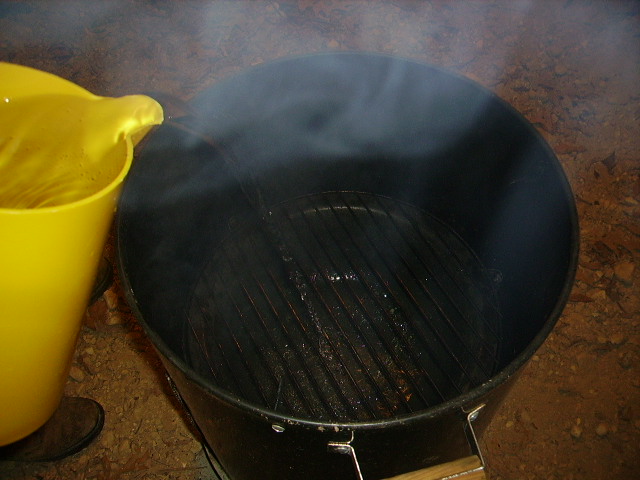 Water pan in place over charcoal and under grill